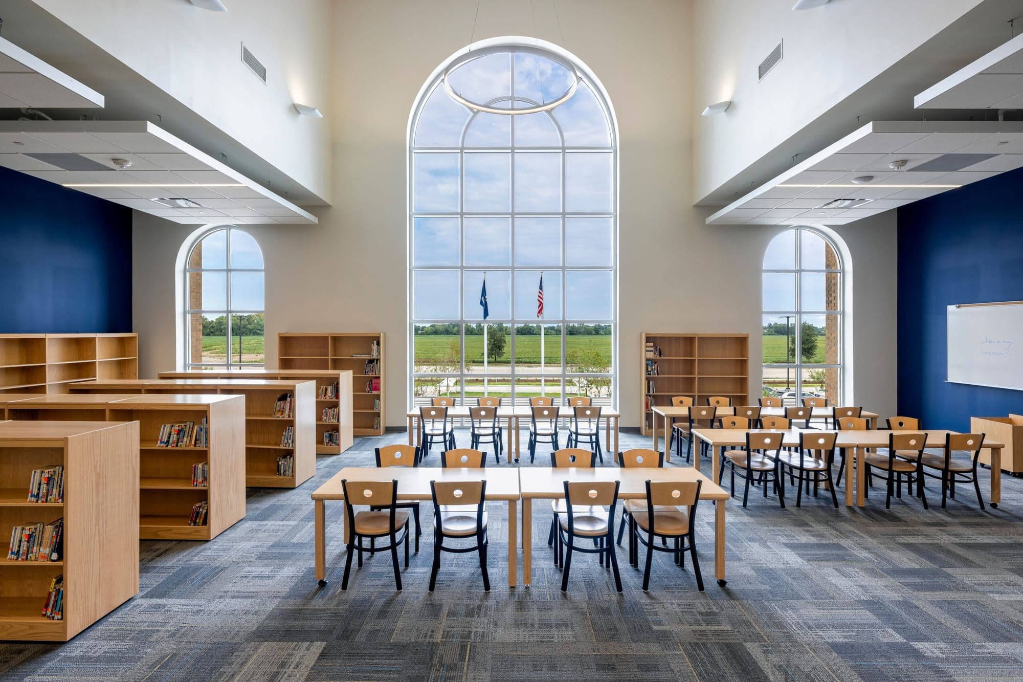 The Harveston study hall — arched window, wood furniture, US and Louisiana flags
